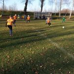 Chłopcy grają w piłkę na boisku